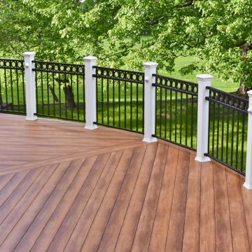 Curved wood-look deck with black metal railing and white posts