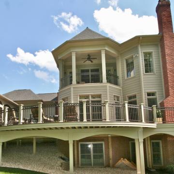 Elevated curved deck with screened porch and covered upper balcony