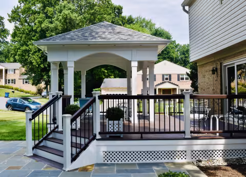 Open air porch with hipped roof, steps, and black railings